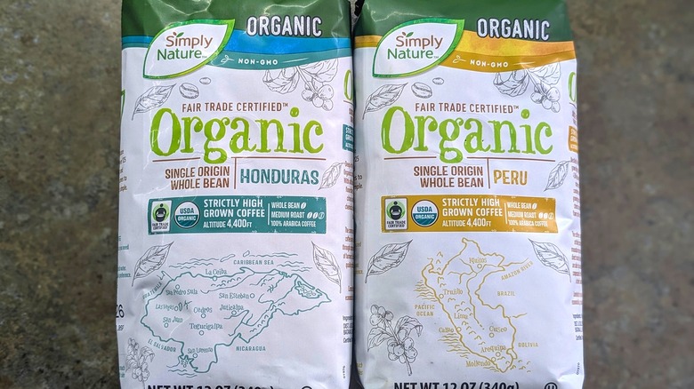 Two bags of Simply Nature organic coffee side-by-side on granite countertop