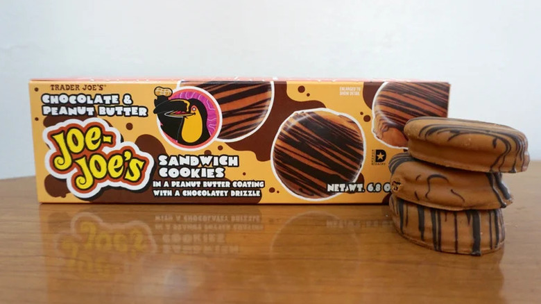 Three Chocolate & Peanut Butter Joe-Joe's stacked on a table in front of the box