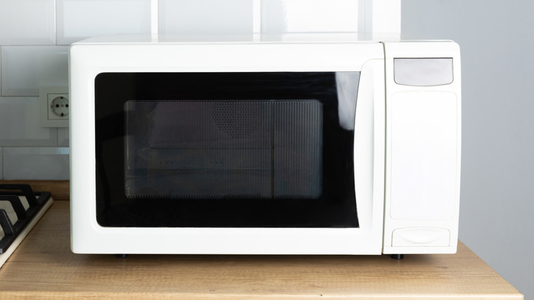 Generic white microwave with black glass, placed on a counter