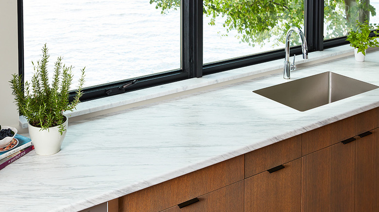 A kitchen featuring a FORMICA laminate countertop in a white marble pattern