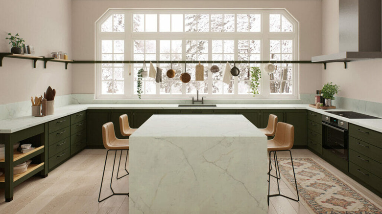 A spacious kitchen with a white Caesarstone porcelain island in a marbled pattern