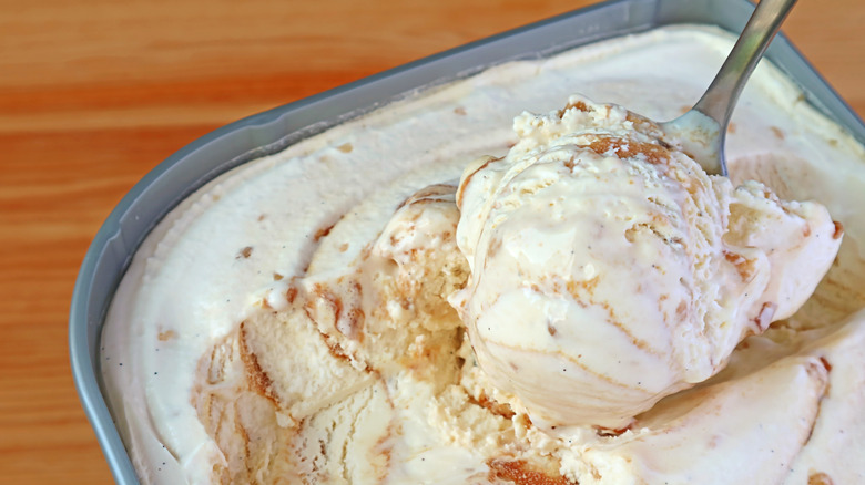 Close-up image of a spoon scooping out a serving of vanilla caramel ice cream