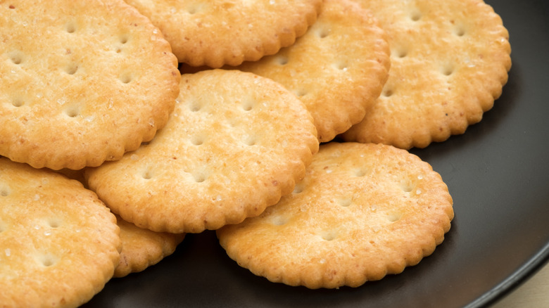 Ritz crackers arrayed on a black plate
