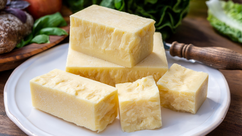 a plate with chunks of cheddar cheese