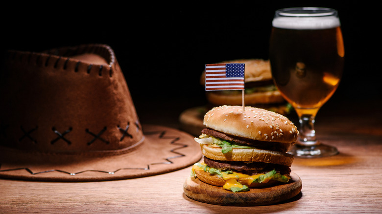 Burger plated beside a cowboy hat