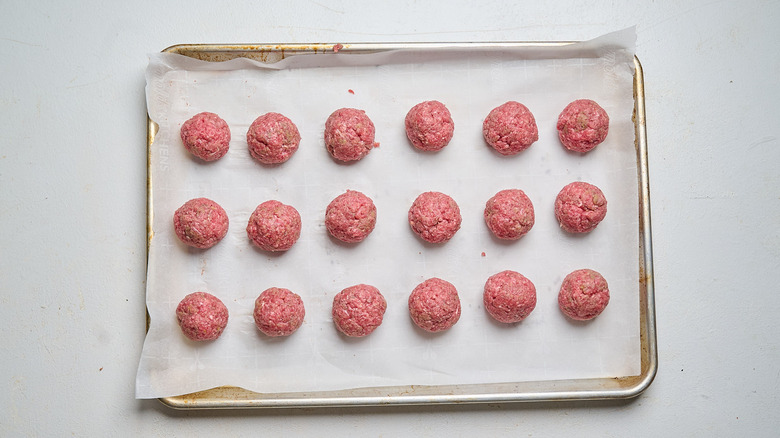 meatballs arranged on a sheet tray