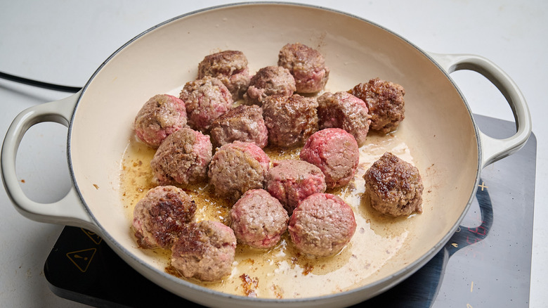 searing meatballs in a skillet