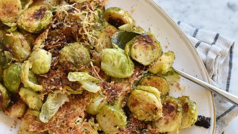Crispy Parmesan-crusted Brussels sprouts in a dish with a spoon