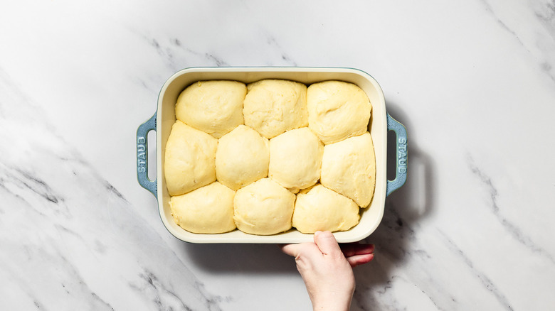 Proofed balls of dough in baking dish