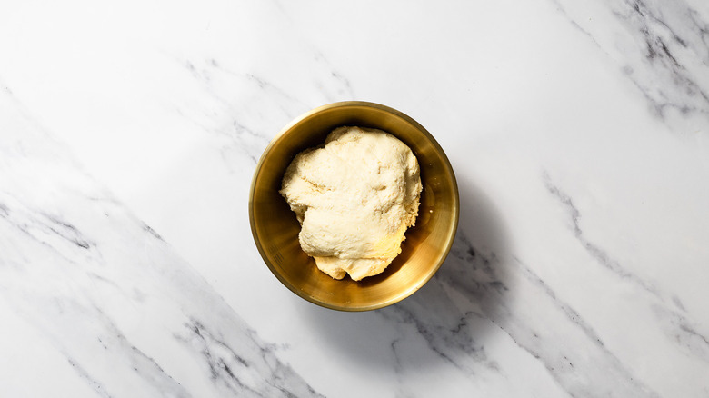 Dough in gold bowl