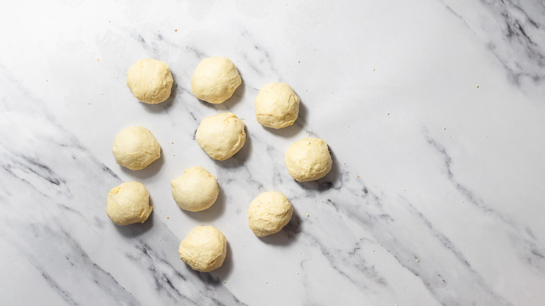 Balls of dough on marble background