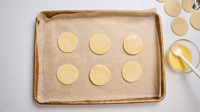 brushing bottom crusts with egg wash