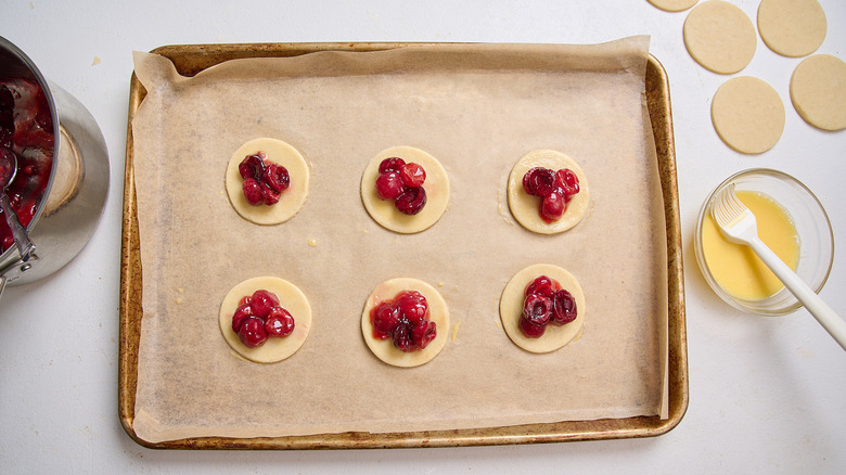 cherry filling added to the centers of the pie crusts