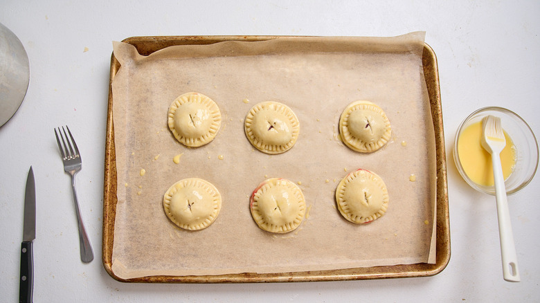 hand pies on sheet tray with sliced top crusts