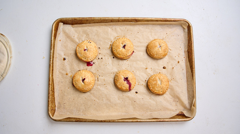 baked cherry hand pies on a sheet tray