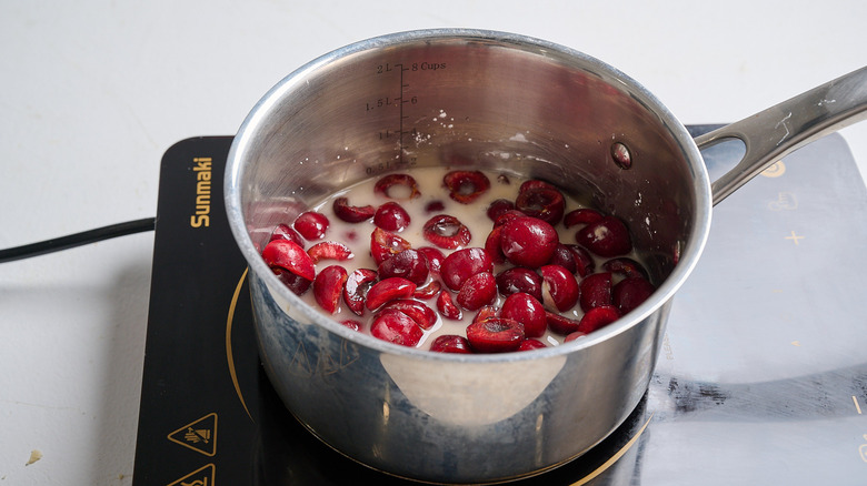 Cherries, water, and sugar in a saucepan