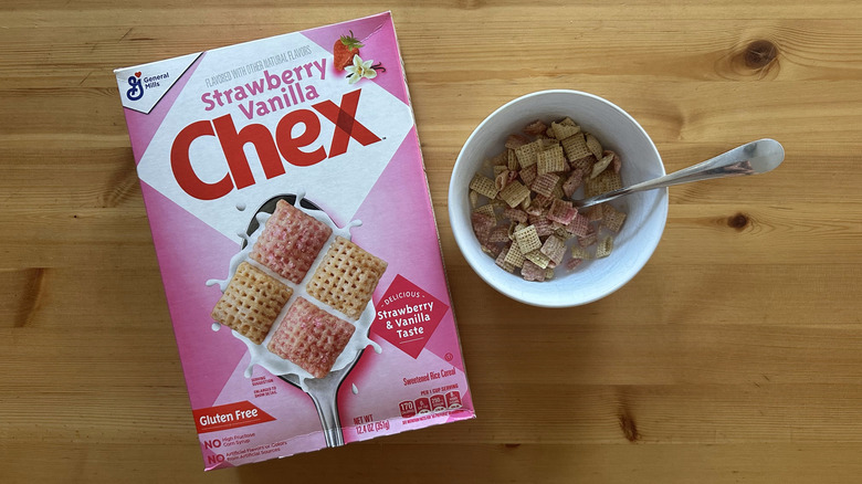 Box of Strawberry Vanilla Chex with some cereals in a bowl with milk on a wooden table