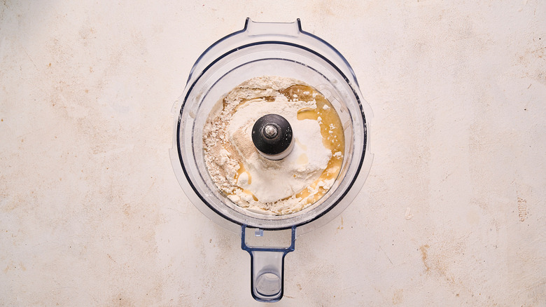 pulsing dough ingredients in food processor