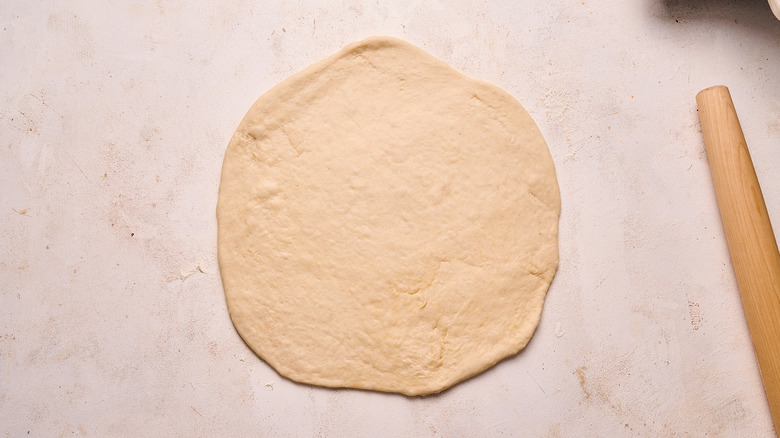 rolling dough into circle