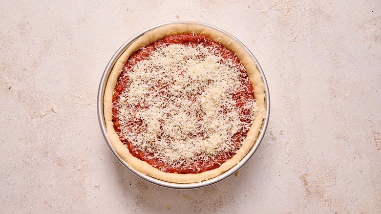 pizza sprinkled with romano cheese