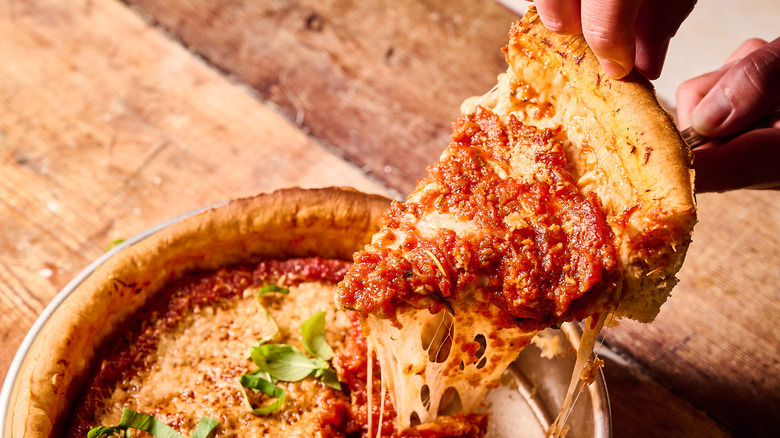 pulling slice of pizza out of pan