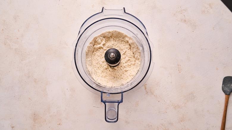 dough ingredients pulsed in a food processor