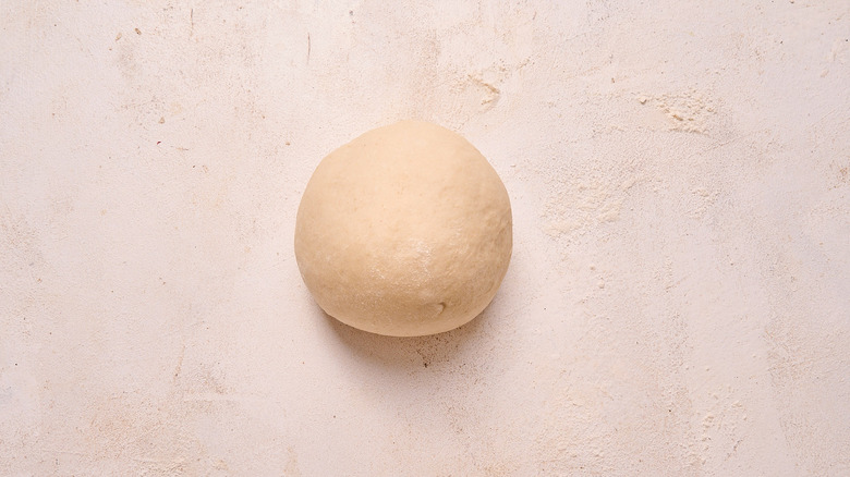 kneading dough into a ball