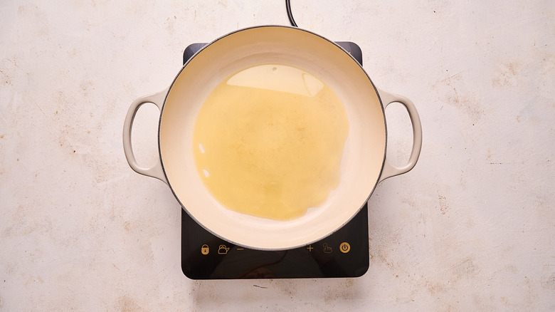 heating olive oil in a skillet