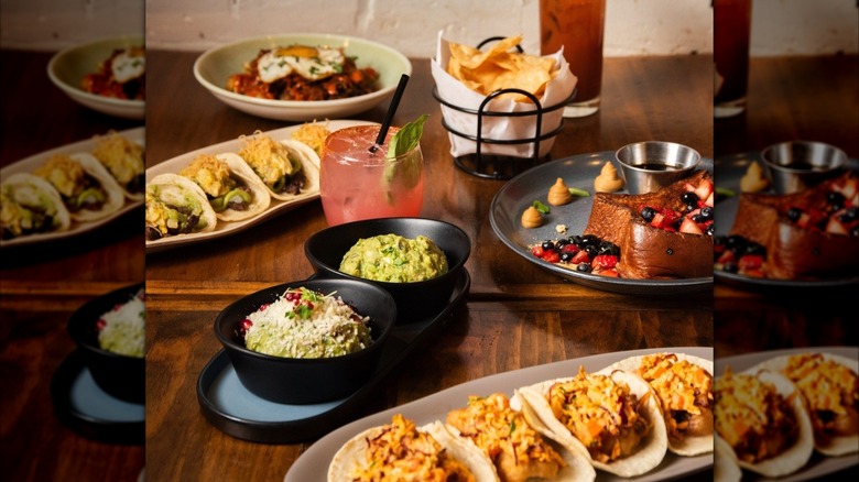 Brunch dishes from Chicago restaurant Mercadito River North on table, including tacos, French toast, cocktails and gucamole