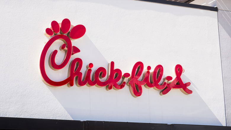 Red Chick-fil-A sign on white building