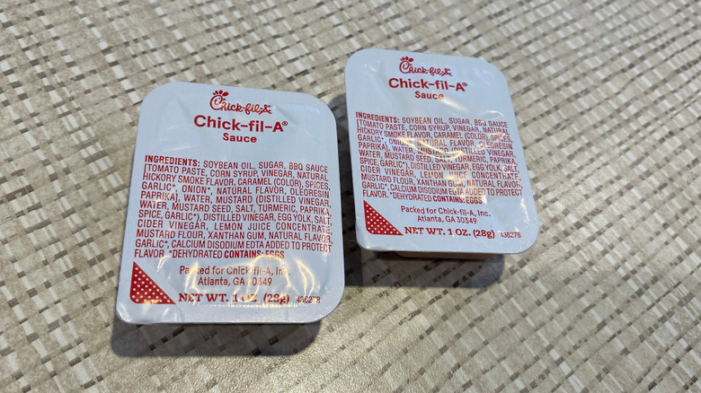 Two Chick-fil-A sauce packets on table