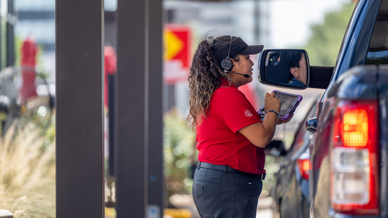 Chick-fil-A worker taking an order outside of car