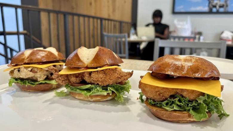 Grilled, original, and spicy Chick-fil-A Pretzel Cheddar Club Sandwiches on a platter