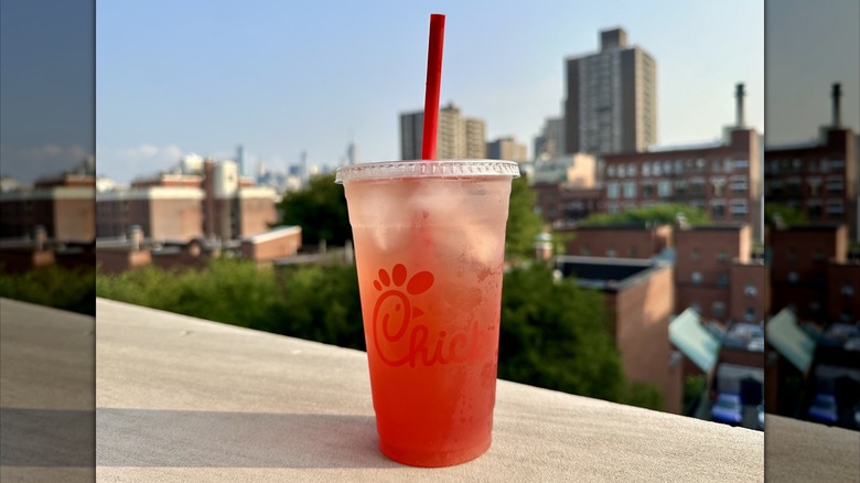 Chick-fil-A Cherry Berry & Sprite sitting on a rooftop ledge outside