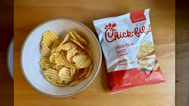 A bowl of Chick-fil-A Sauce Flavored Waffle Potato Chips next to packaging