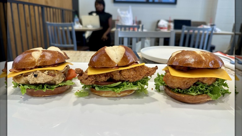 Grilled, original, and spicy Chick-fil-A Pretzel Cheddar Club Sandwiches on a platter