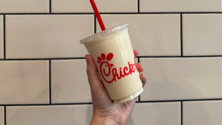 hand holding up a Chick-fil-A Peach Frosted Lemonade