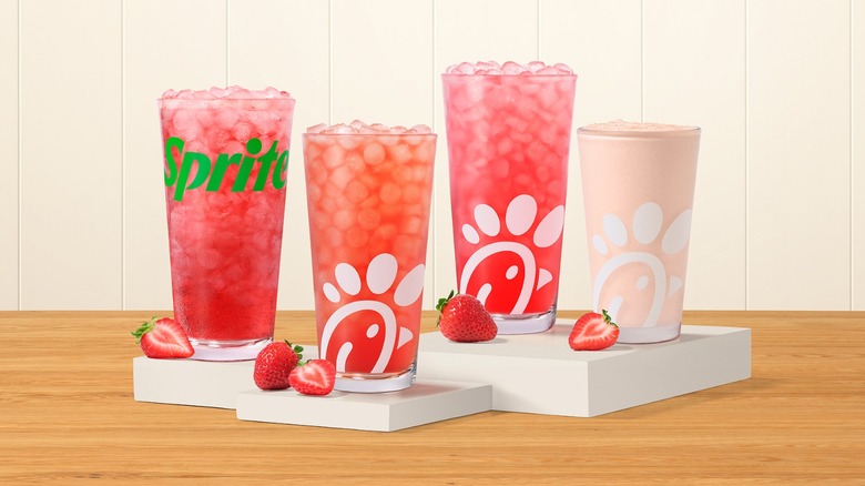 Four Chick-fil-A strawberry hibiscus drinks on white pedestals