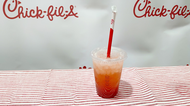 The strawberry hibiscus lemonade on a striped tablecloth