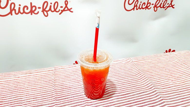 The strawberry hibiscus Sunjoy on a striped tablecloth