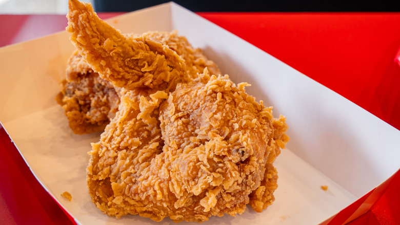 Piece of KFC fried chicken in tray