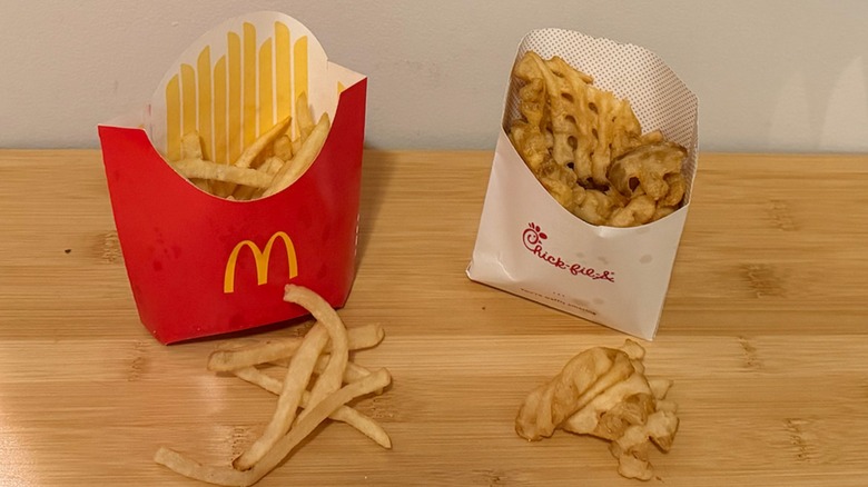 McDonald's french fries and Chick-fil-A french fries on a table side by side