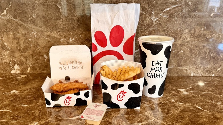 Chick-fil-A's Chick-n-Strips Meal showing the chicken tenders, Chick-fil-A sauce, fountain drink, and waffle fries