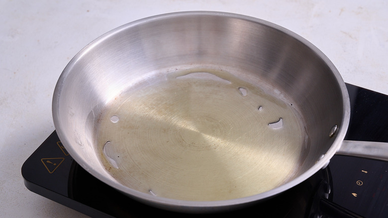 Skillet with oil sitting on heating element