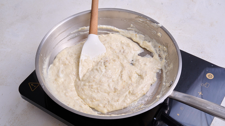 cooking Alfredo sauce in a skillet