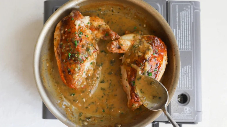 Airline Chicken Breast with Shallot-Mustard Sauce in pan with spoon