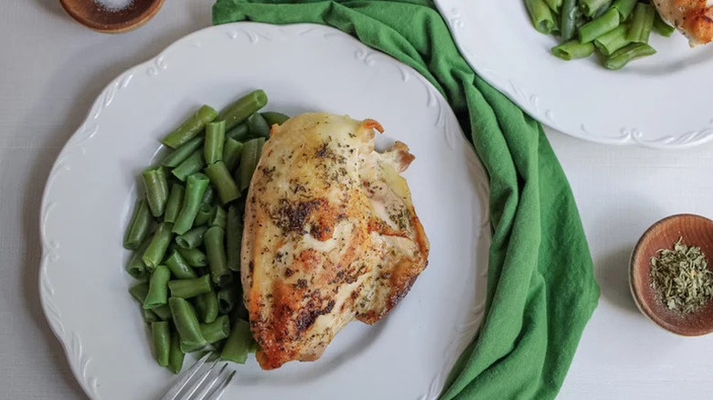Cast-Iron Split Chicken Breast on white plate with green beans