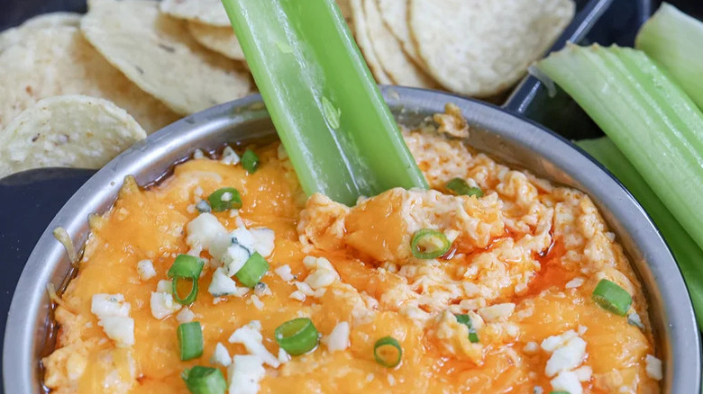 Crock Pot Buffalo Chicken Dip in silver bowl with celery