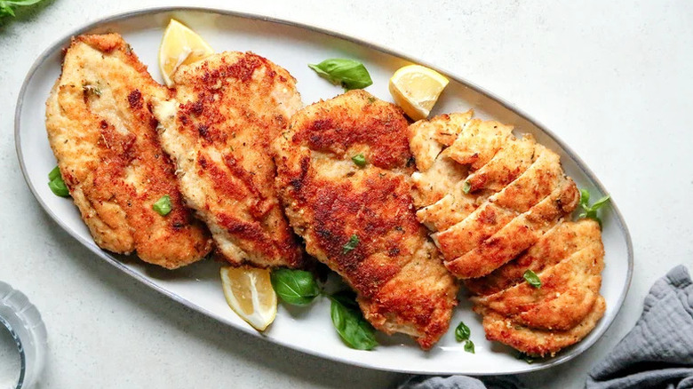 Parmesan-Crusted Fried Chicken Breast on white plate
