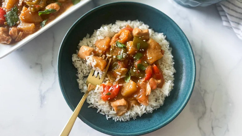 Slow Cooker Hawaiian Chicken on bed of rice in blue bowl